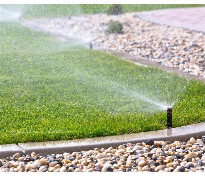 watering lawn with sprinklers